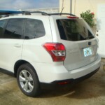 Before and after photographs of a damaged white Subaru that was repaired by Elite Paint & Body Shop in West Palm Beach, Florida